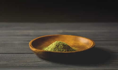 kratom powder in a bowl on table